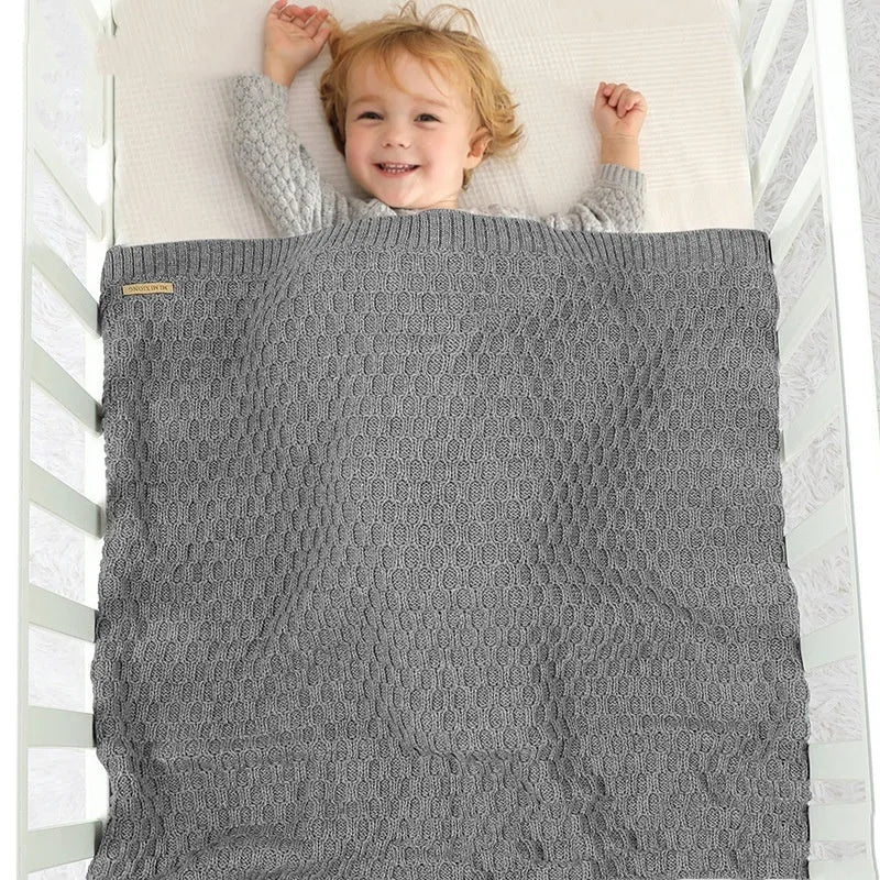 Solid colour infant blanket with raised line texture in beige khaki, laid flat showing 70x90cm size.