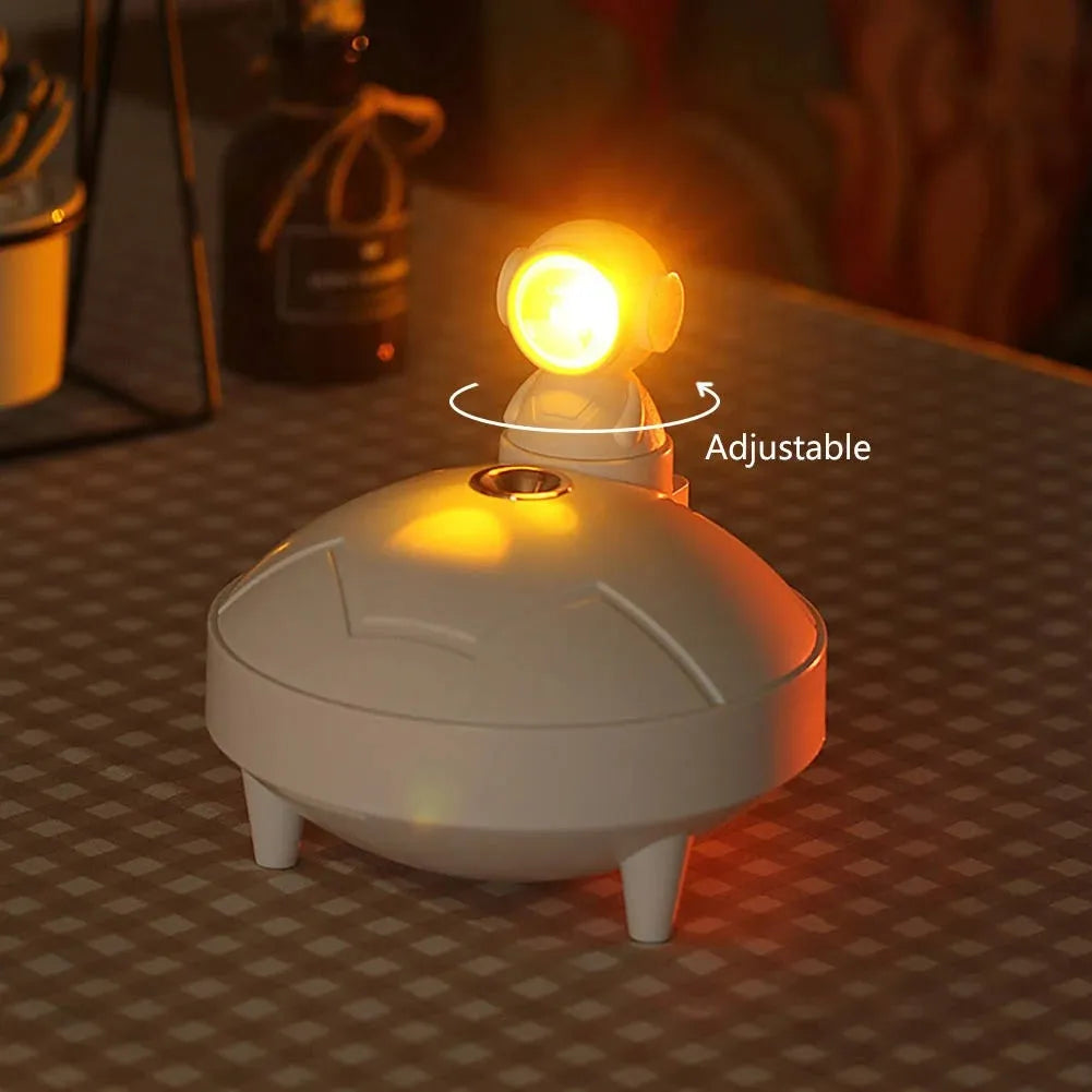Astronaut sunset lamp humidifier with 360 degree rotating head in green colour, placed on a nightstand